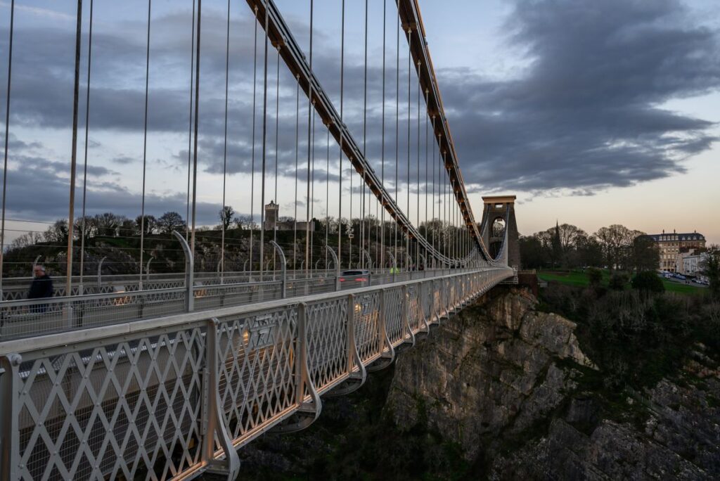 A Local Guide To Clifton 1 A picturesque view of the Clifton Suspension Bridge in Bristol during twilight, showcasing its architectural marvel.